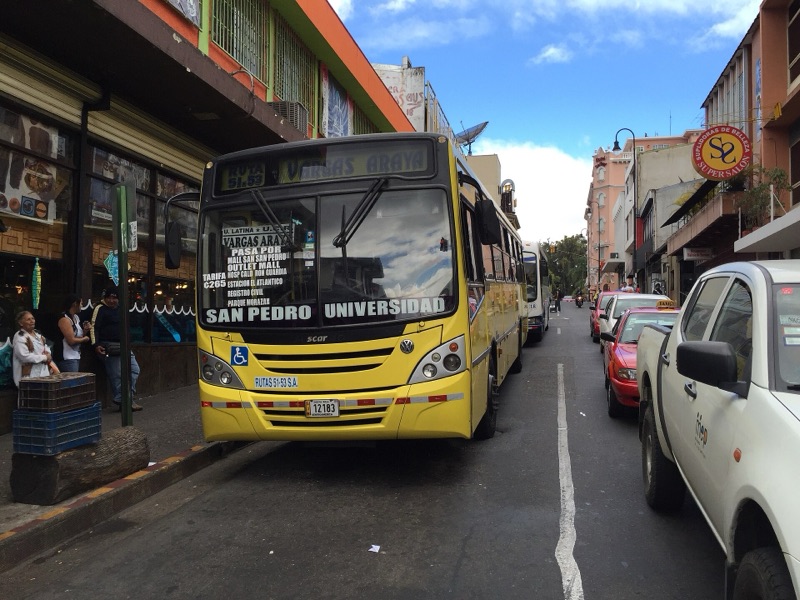 Public buses lined up at a stop in downtown San José, Costa Rica