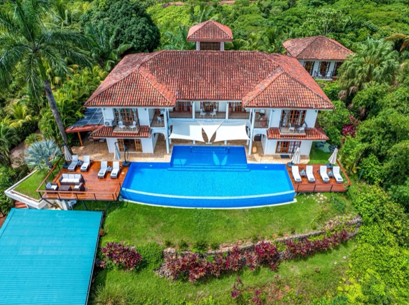 Aerial view of El Castillo and its pool on the forested hillside at Ojochal